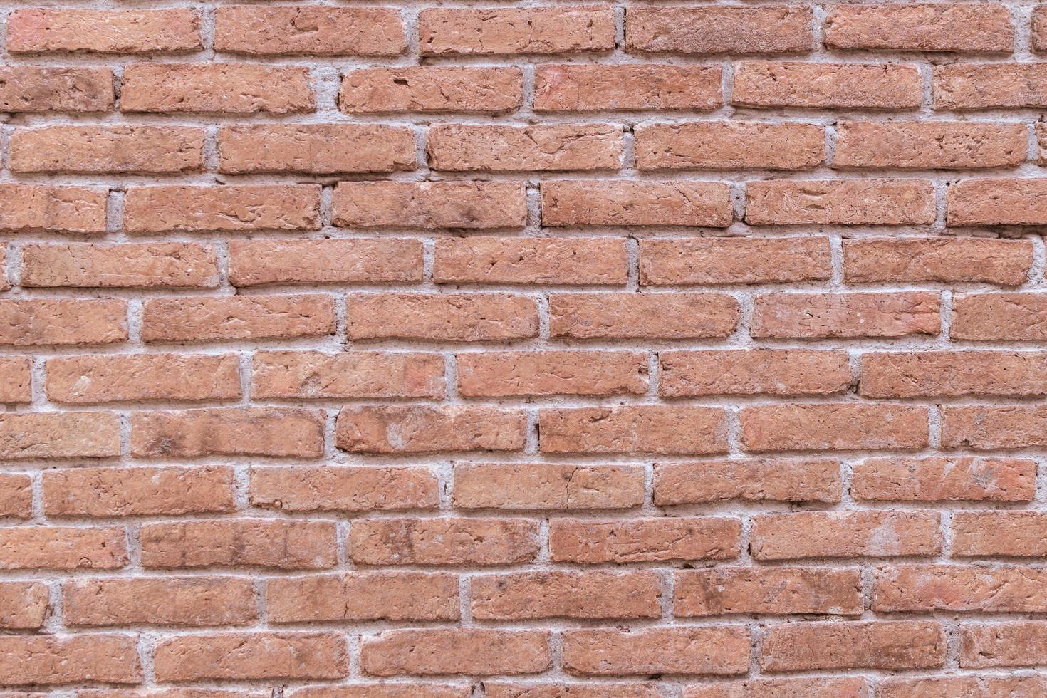 Old grungy red brick wall block pattern and cement surface background.Vintage wallpaper.Rustic stonewall.Brickwork. photo