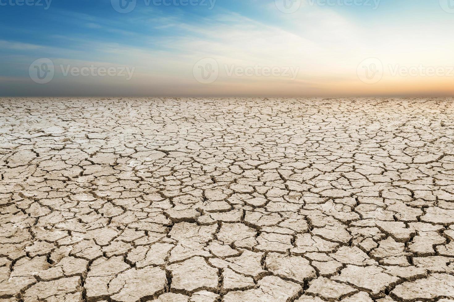 Landscape cracked soil, earth desert terrain with sky photo