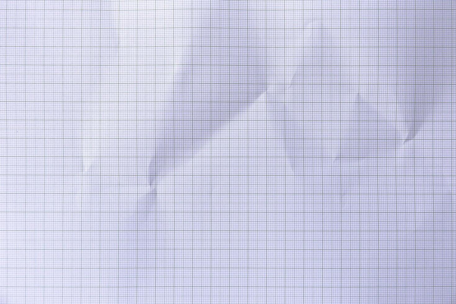 Square crumpled square graph paper on the background. photo
