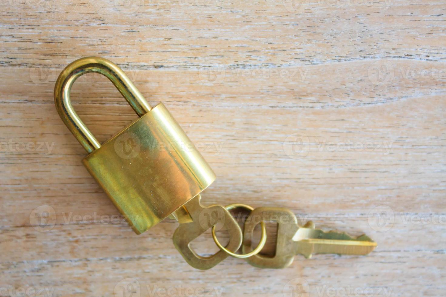 Golden padlock on wood background photo