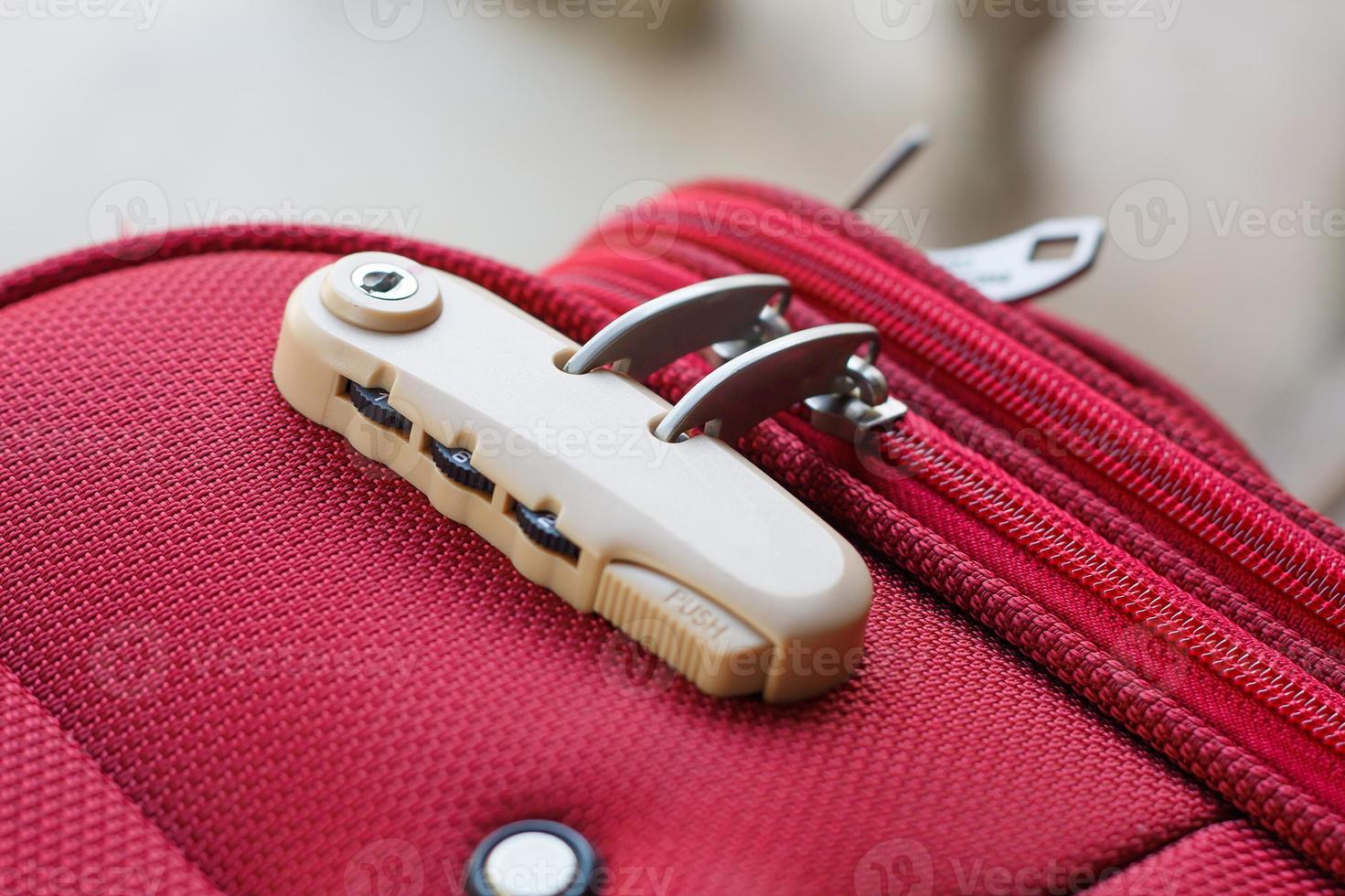 combination lock on red suitcase travel bag photo