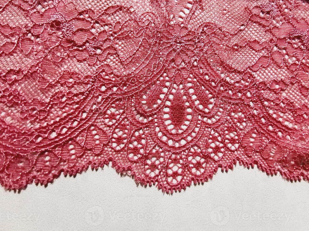 Lace elegant pink fabric. Underwear finishing element on a white background. photo