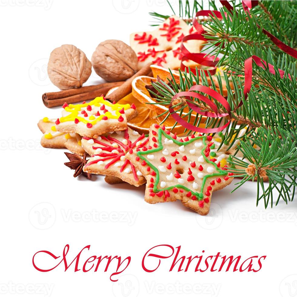 Christmas cookies, spices and spruce branches isolated on white background photo