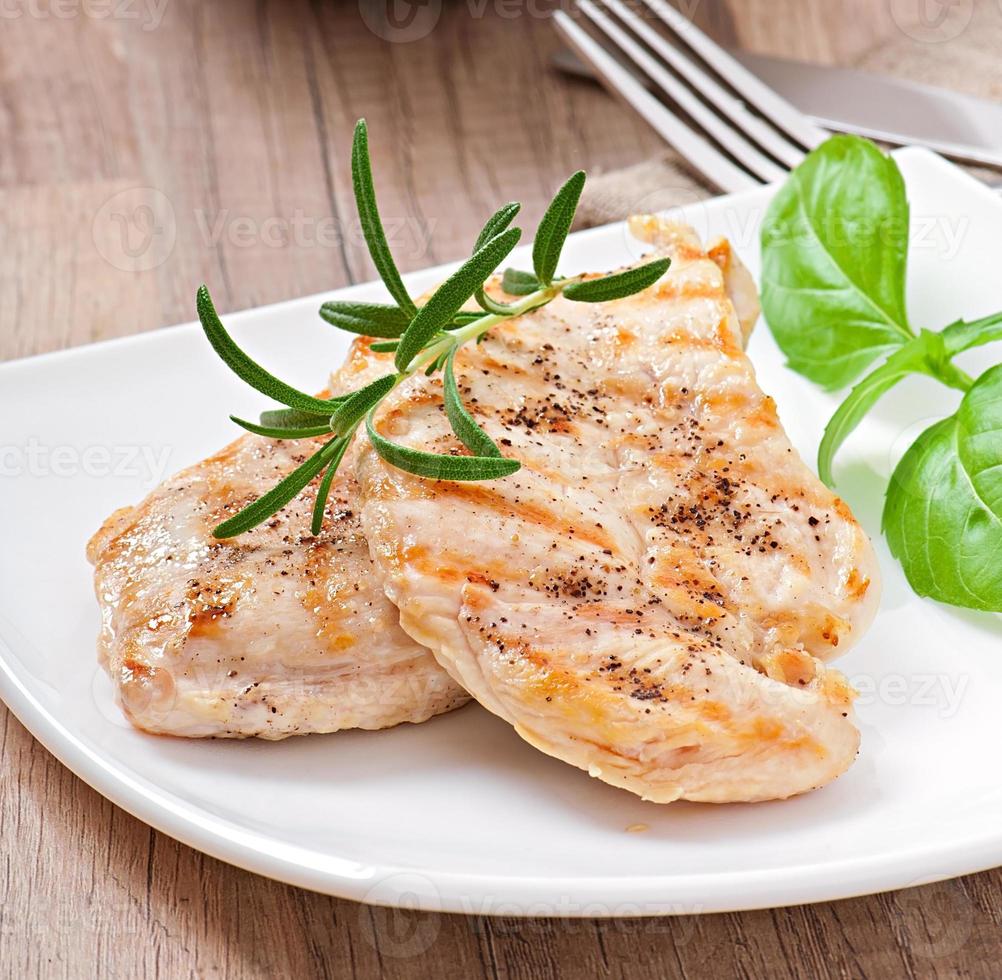 Grilled chicken breasts and vegetables photo