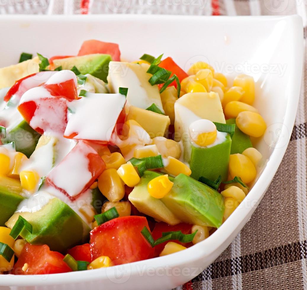 Mixed salad with avocado, tomatoes and sweet corn photo