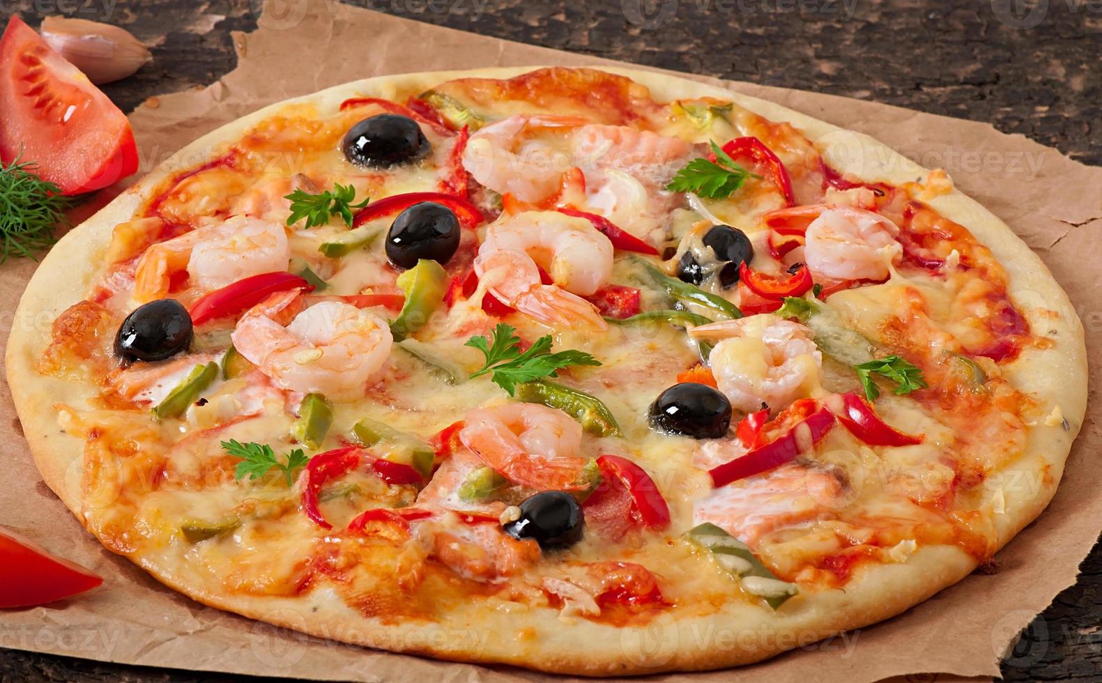 Pizza with shrimp, salmon and olives photo