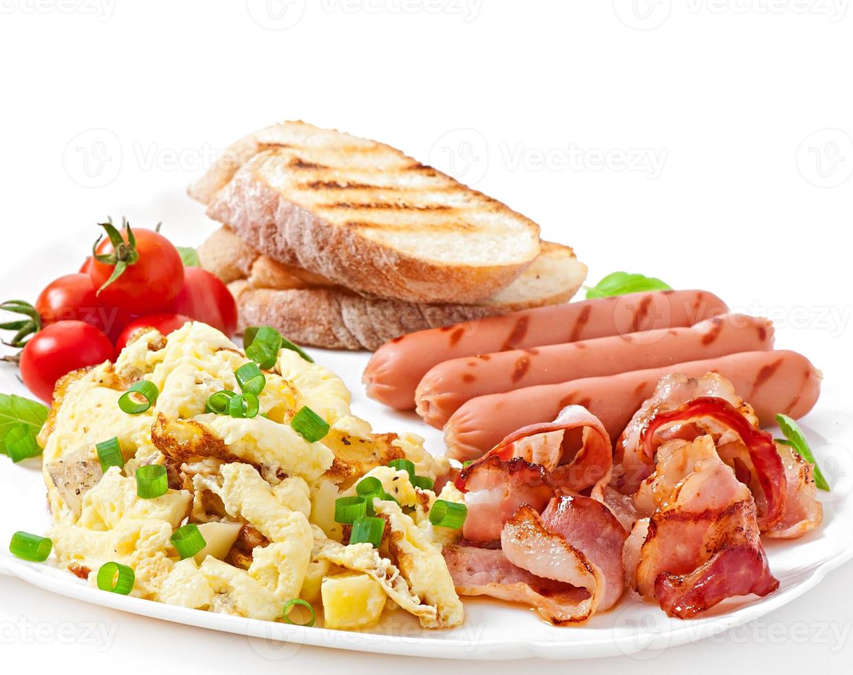 English breakfast - scrambled eggs, bacon, sausage and toast photo
