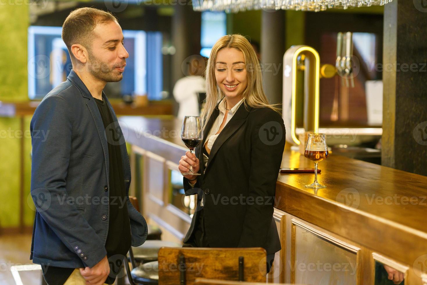 Happy diverse couple spending time in pub photo