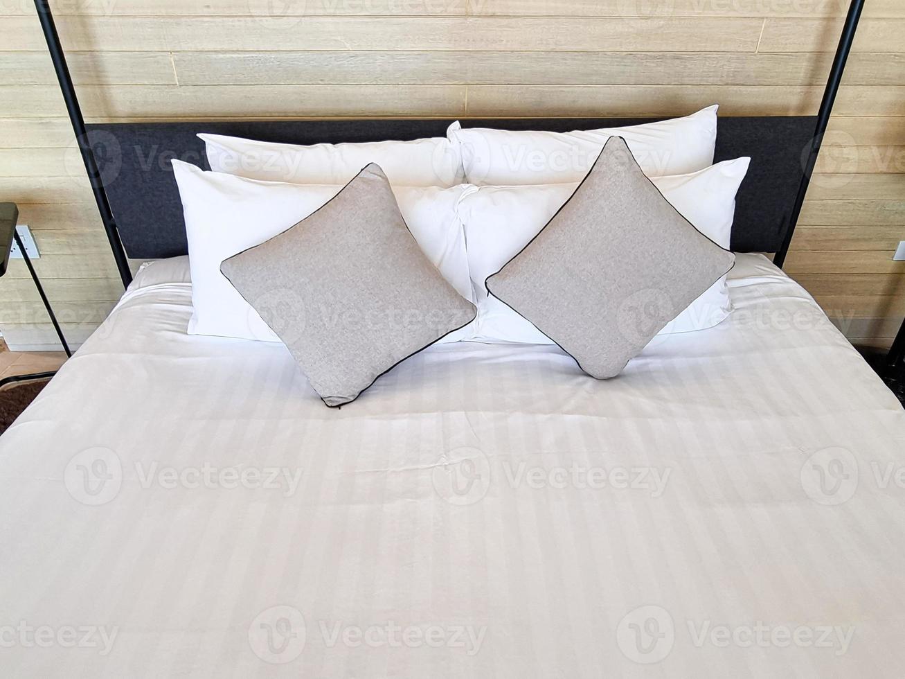 white bedsheet prepare on bed room. with pillow. clean interior comfort service room in spa and hotel photo