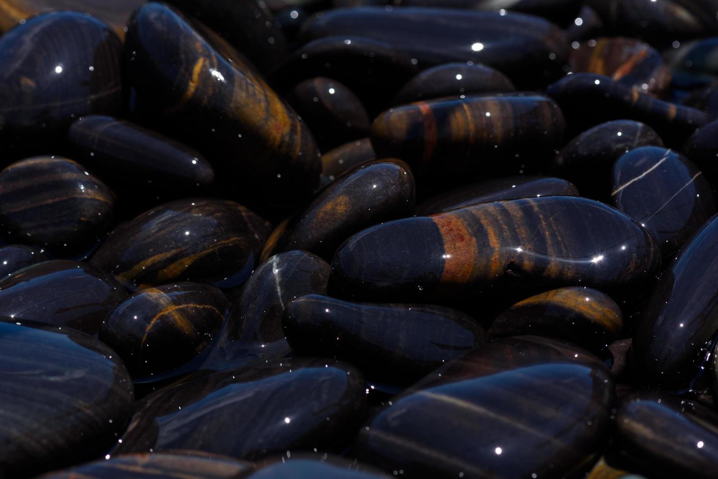 Close-up view of beautiful black stones on the beach photo