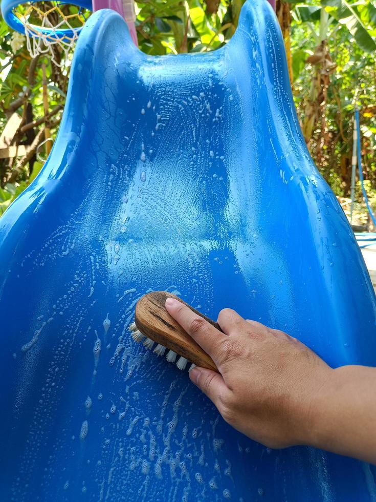 scrubbing brush cleaning on the slider of children's toys. photo