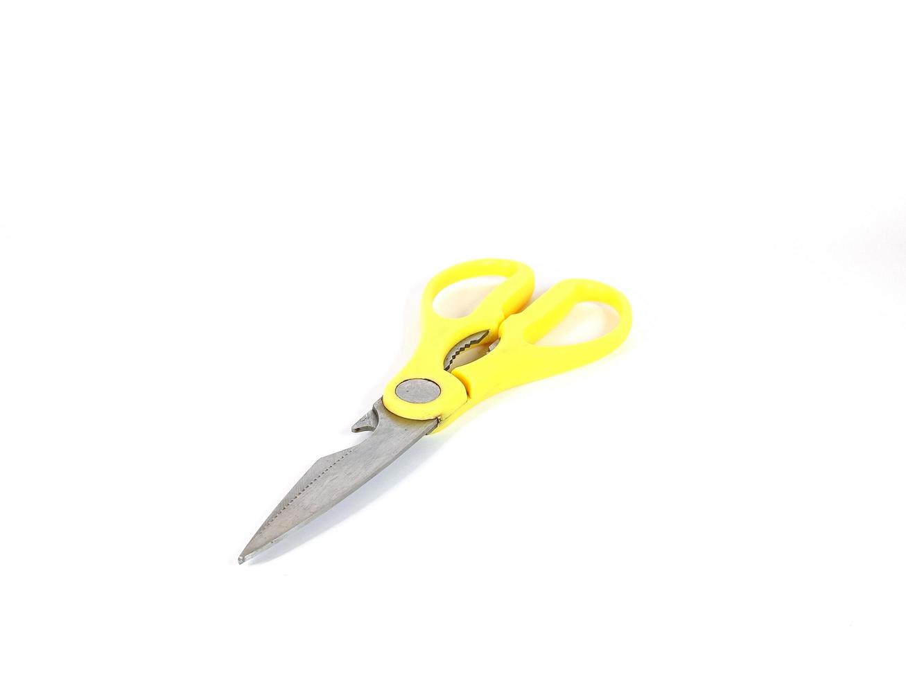 small old yellow scissors on a white background photo