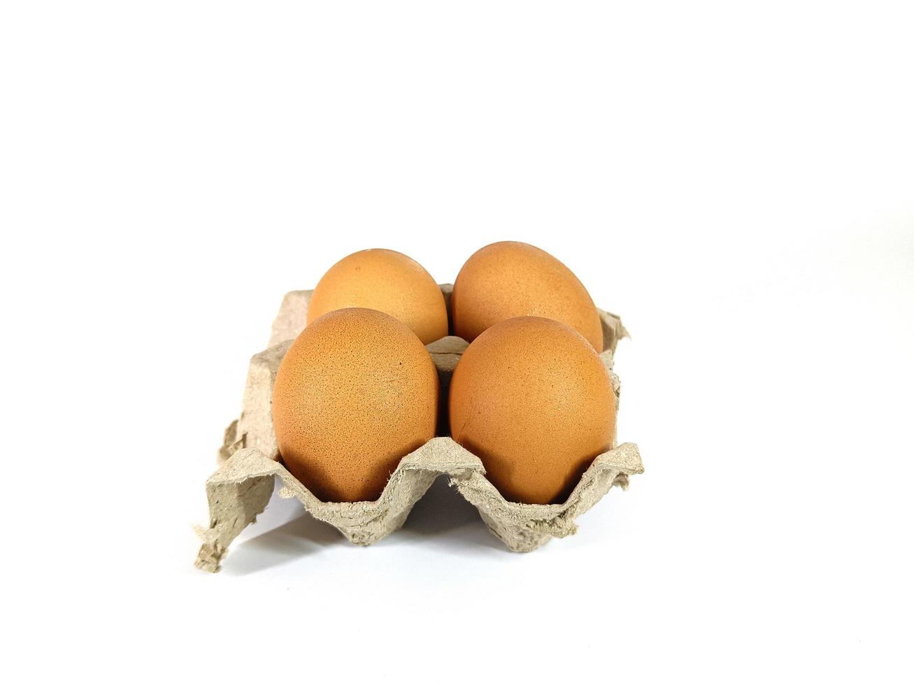 Eggs on recycled cardboard boxes on a white background photo