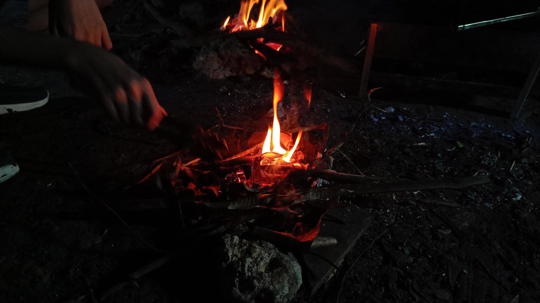 small bonfire in a natural forest camping site. photo
