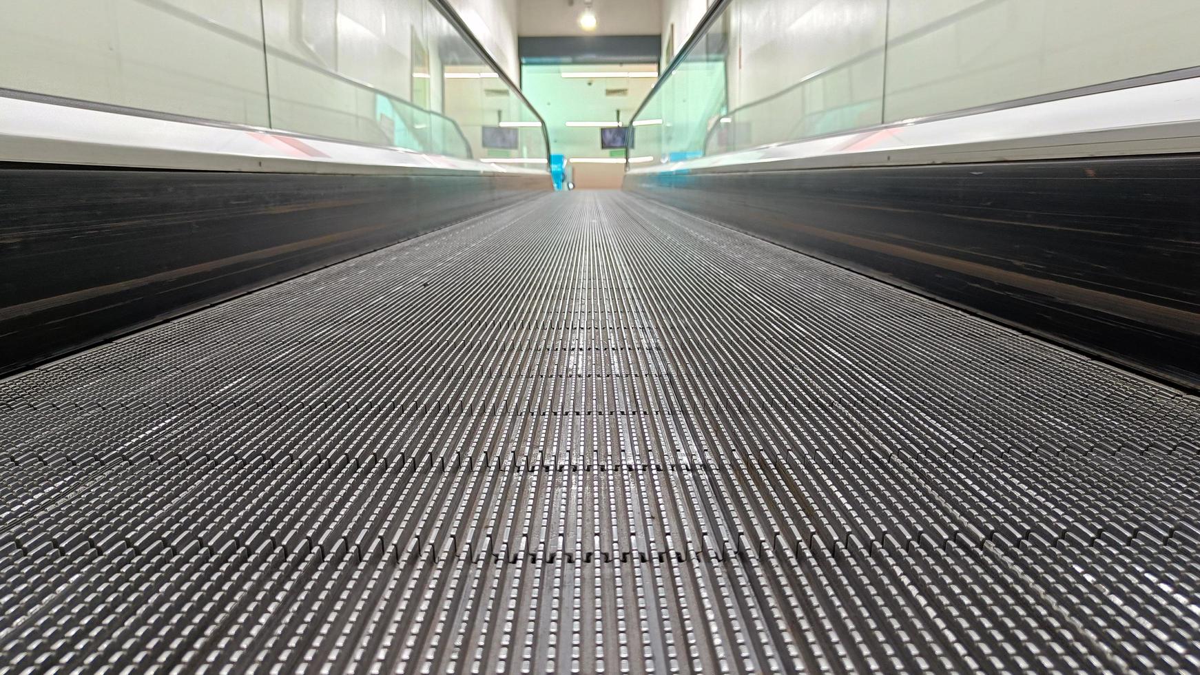 Modern escalator at metro station or supermarket photo