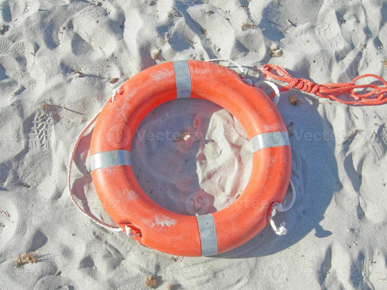 Isolated orange life buoy photo