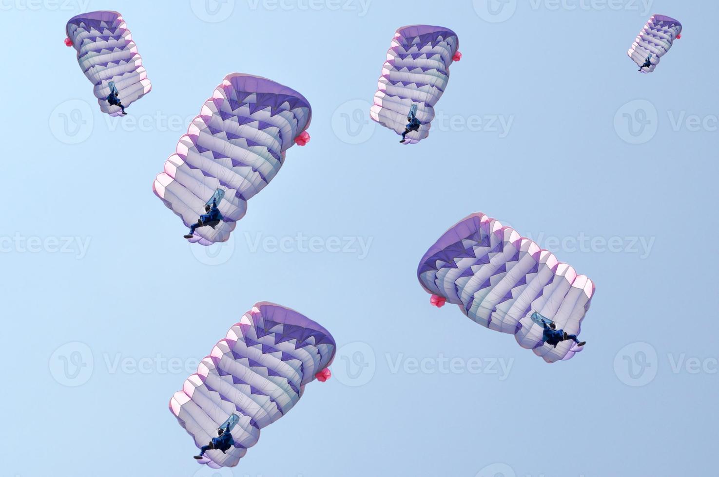 Many parachutes over a blue sky background photo