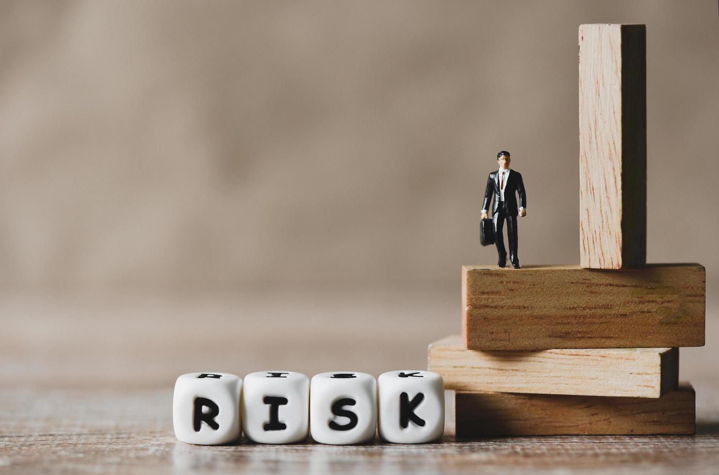 Risk business concept, business man stands on wooden blocks. risk control and managment idea photo