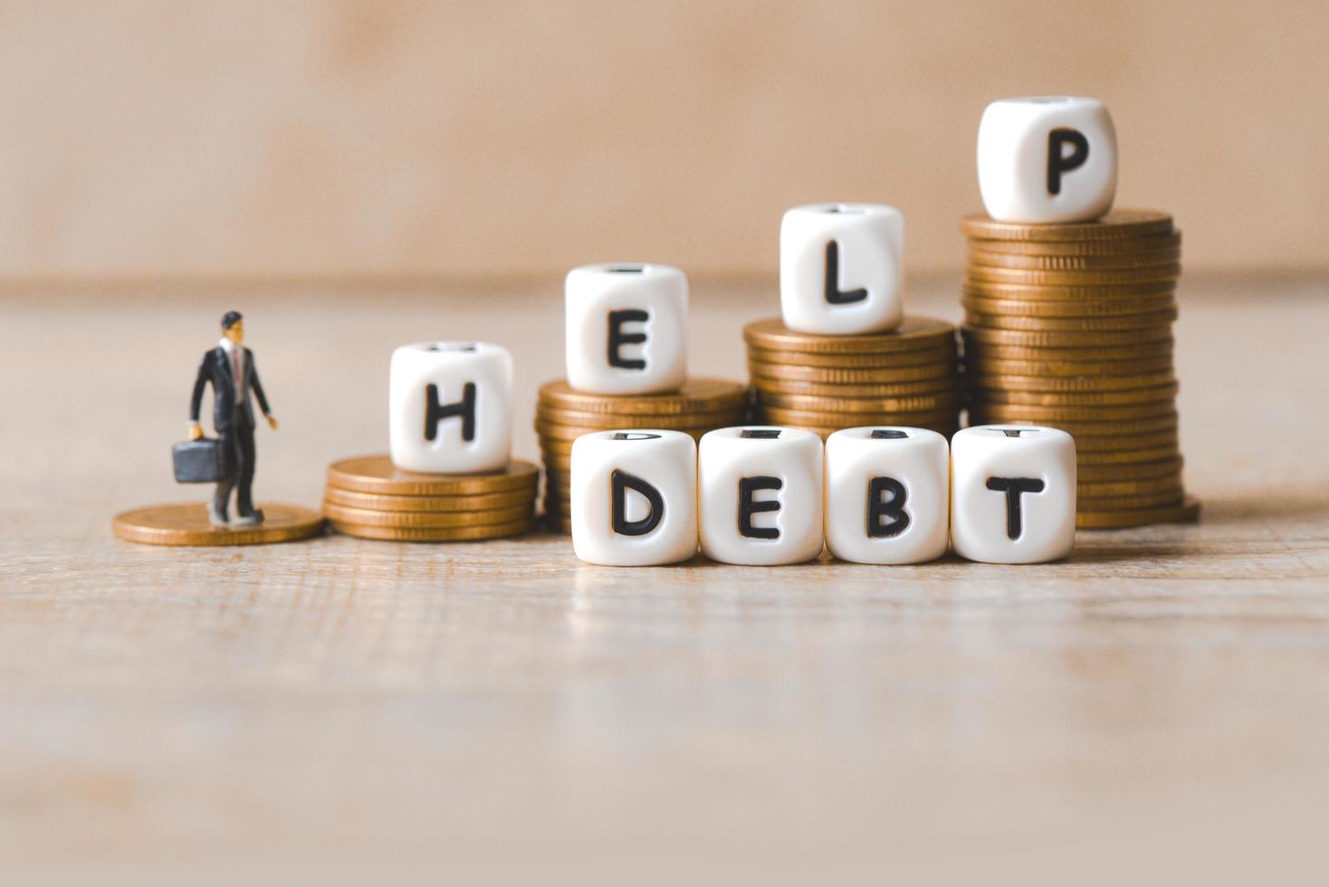 Block word hepl debt on pile of coins with business man, Payment of taxes and of debt to the state, Concept of financial crisis and problems risk management debt exemption loan photo