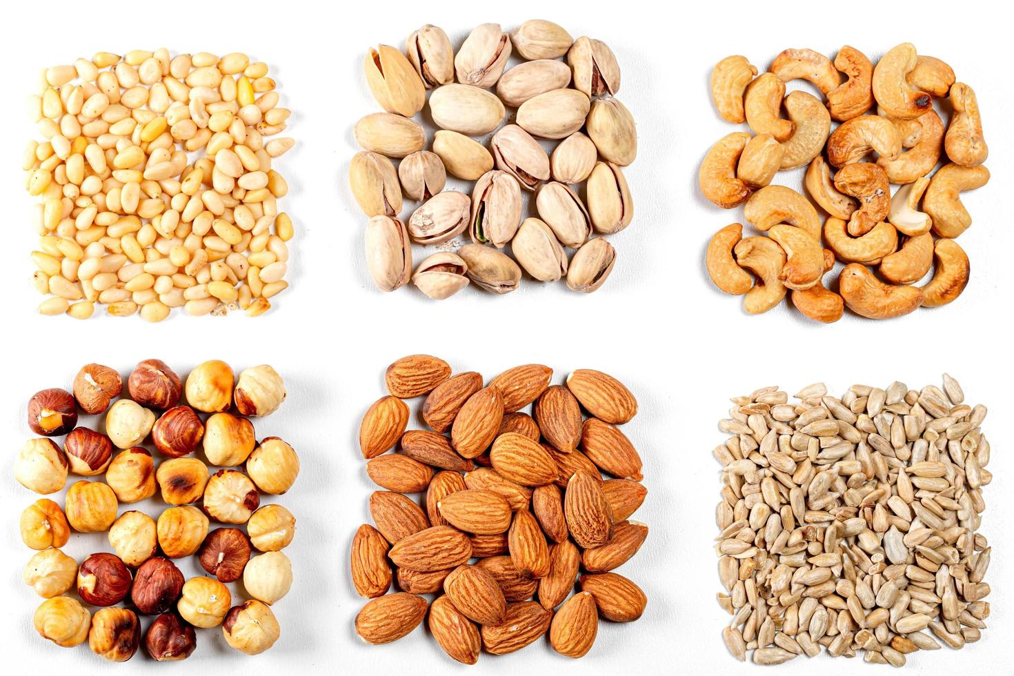 Cashew nuts, pistachios, pine nuts, almonds, hazelnuts and sunflower seeds on a white background photo