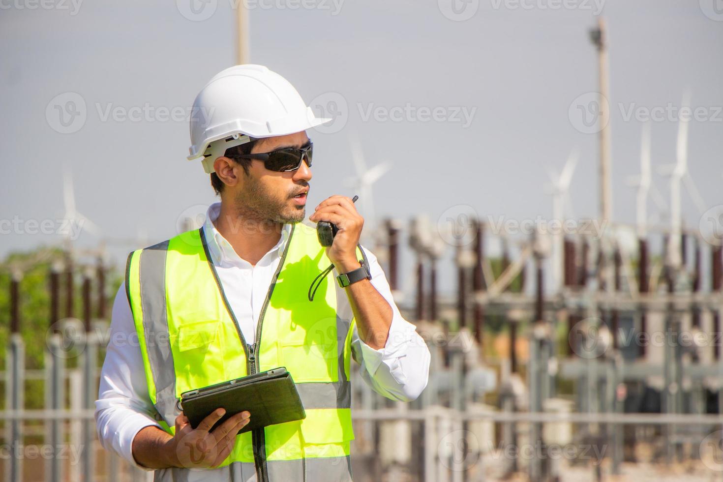engineer team working in wind turbine farm. Renewable energy with wind generator by alternative energy concept. photo