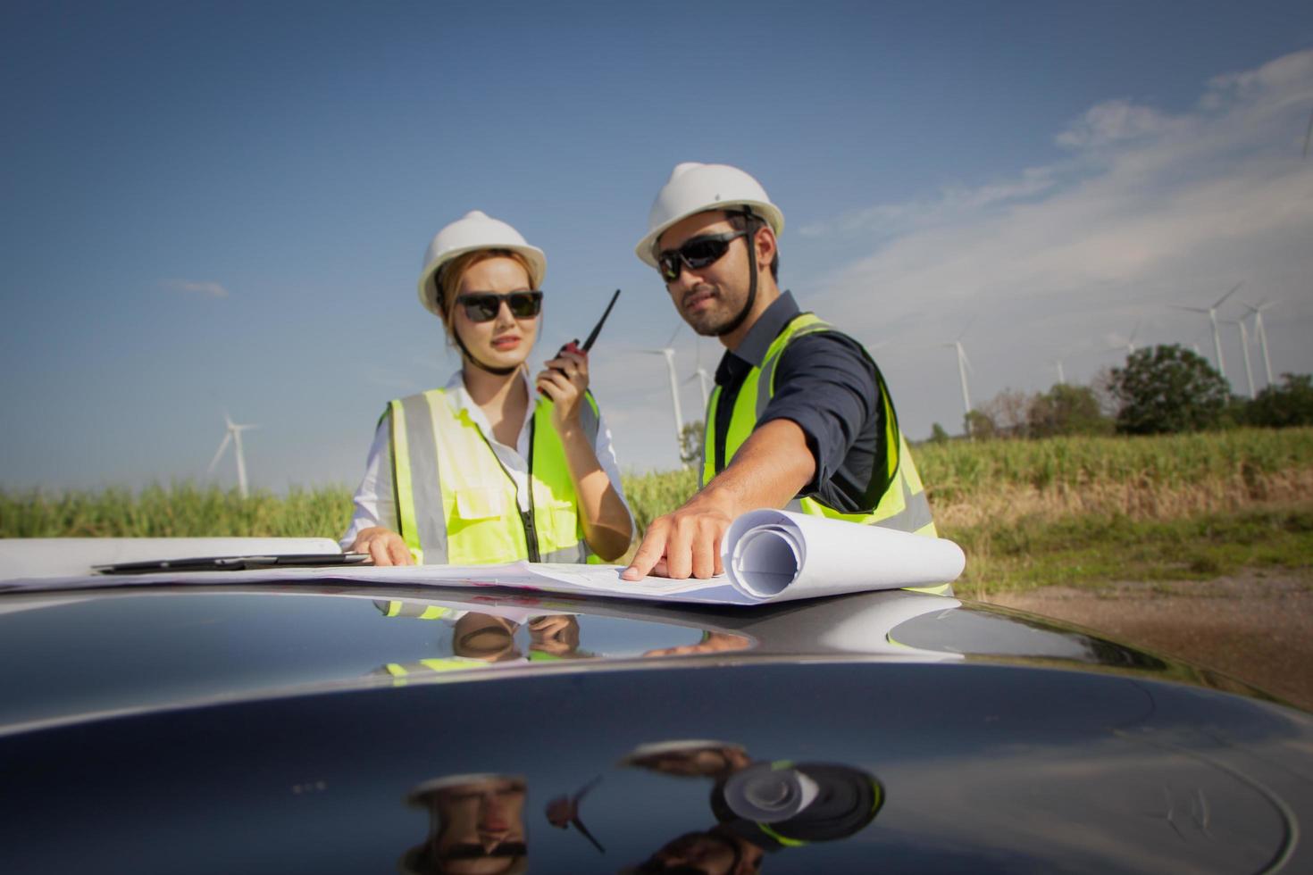 engineer team working in wind turbine farm. Renewable energy with wind generator by alternative energy concept. photo