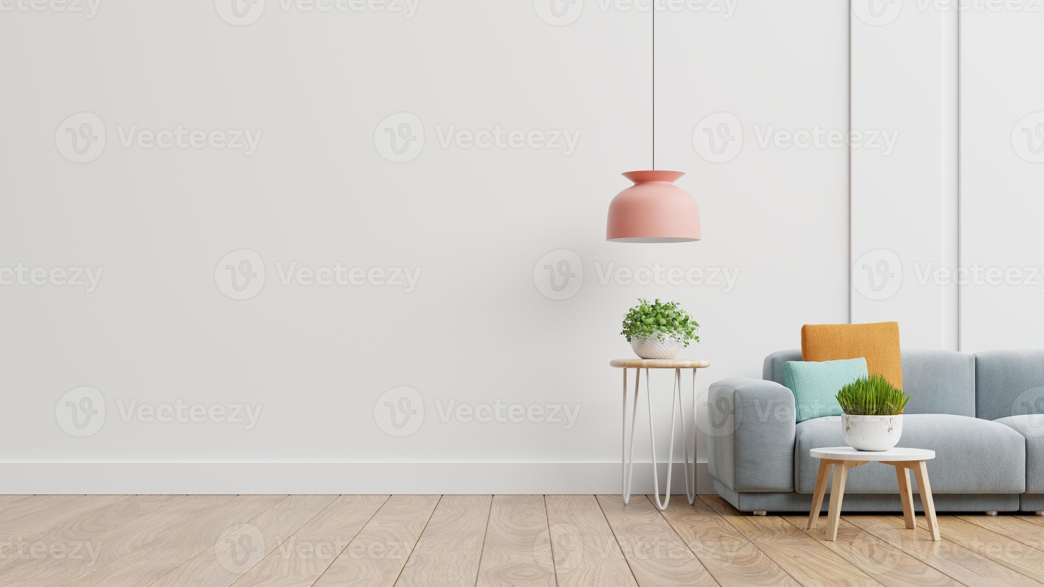 Empty living room with blue sofa, plants and table on empty white wall