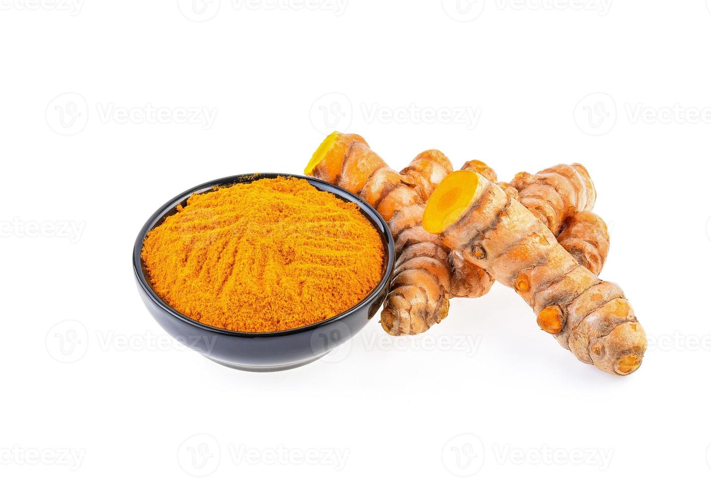 Turmeric roots with turmeric powder isolated on white background photo