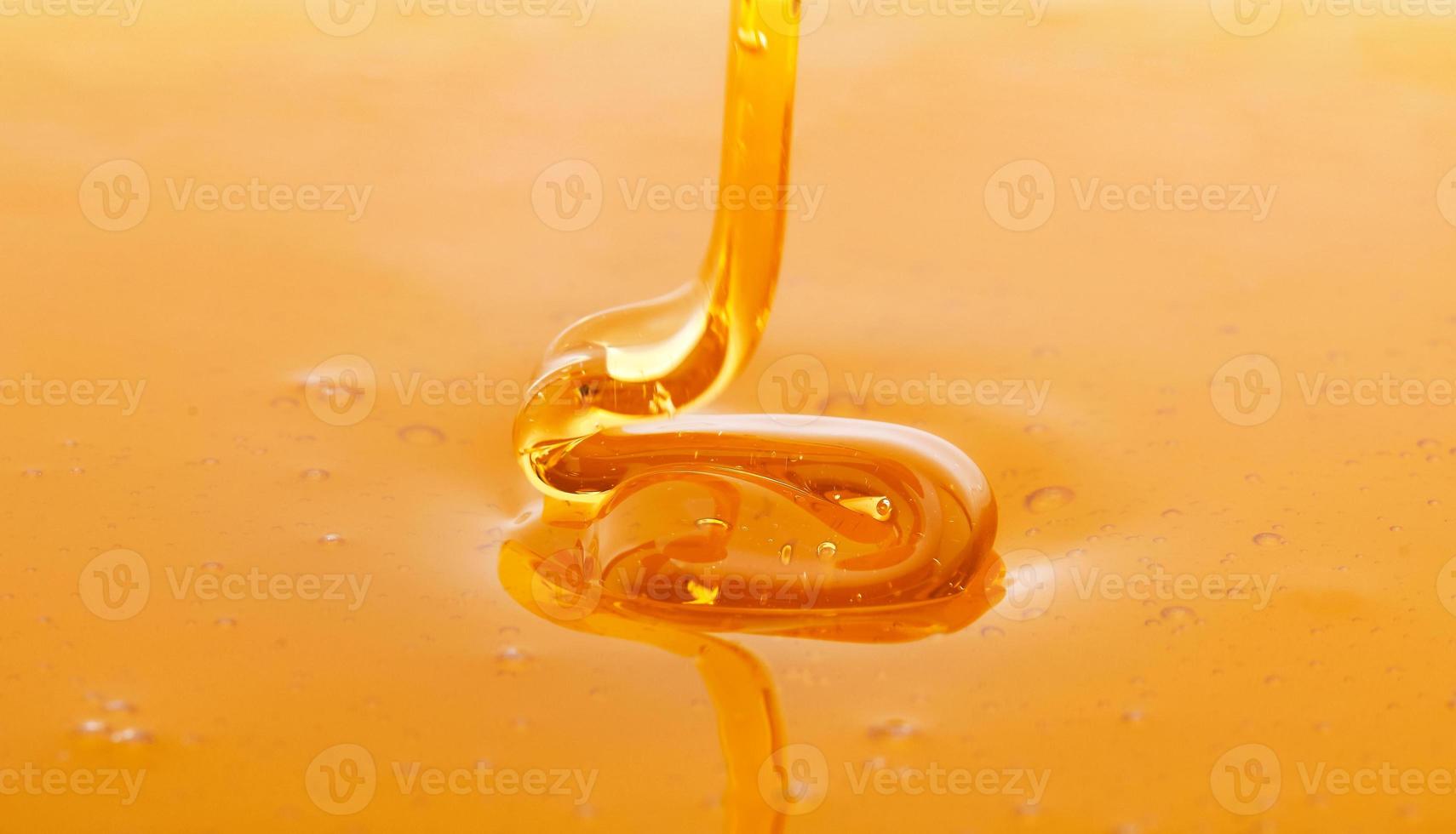 Macro of thick fresh honey dripping photo