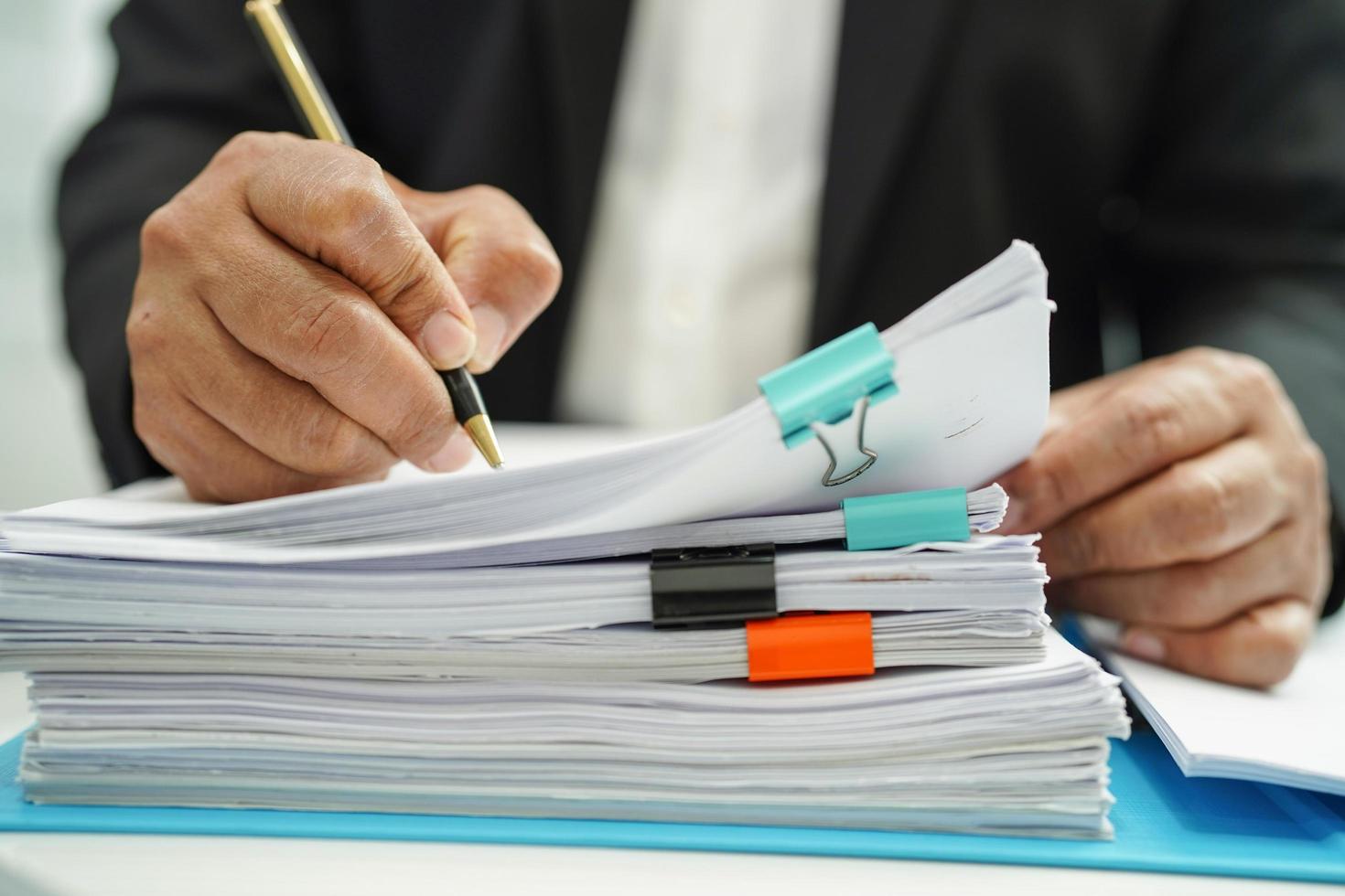 Businessman working and prepare paperwork report data to analysis information in file binder at office. photo