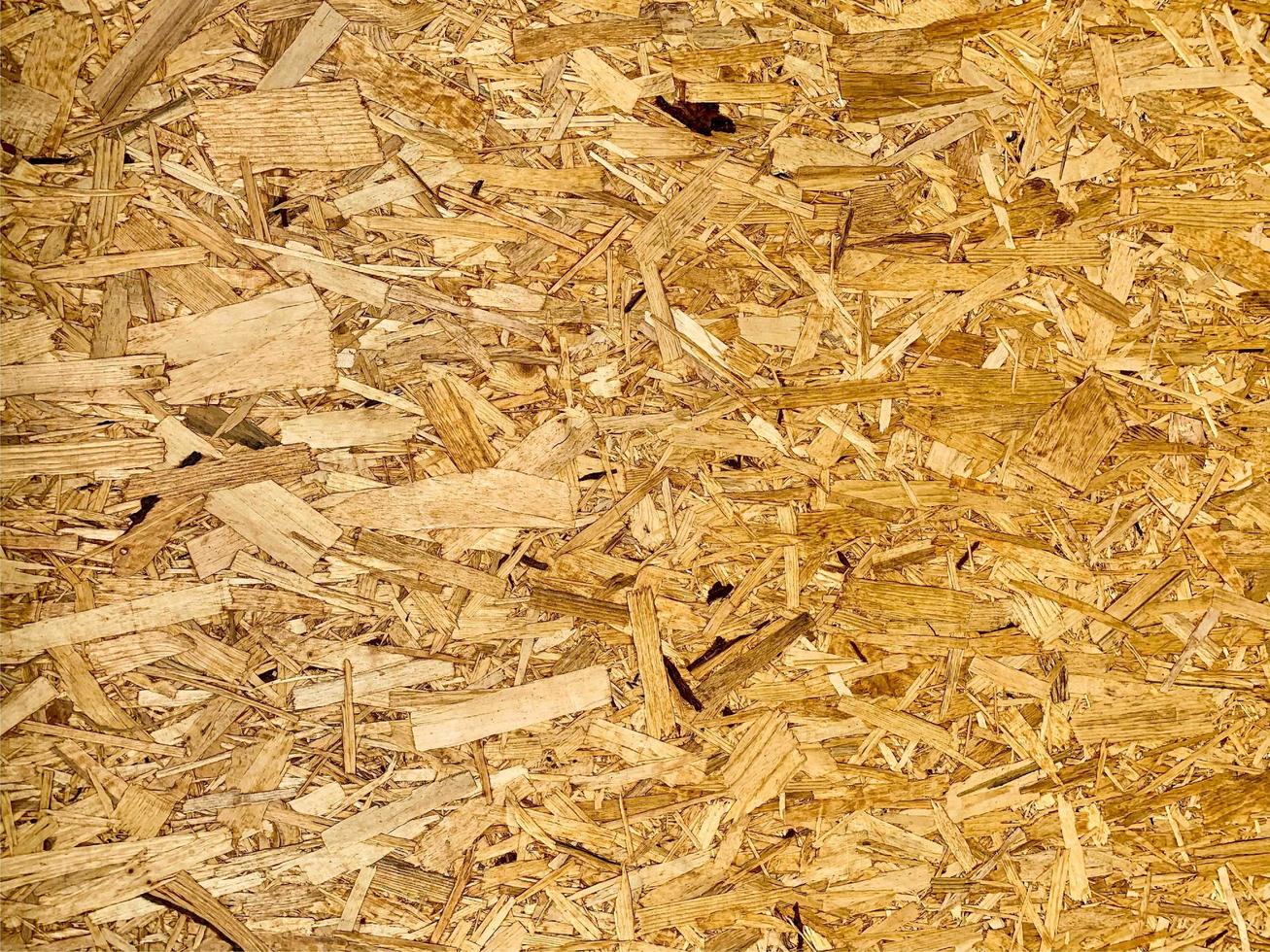 Compressed chipboard background. Wooden plank backdrop. OSB texture photo