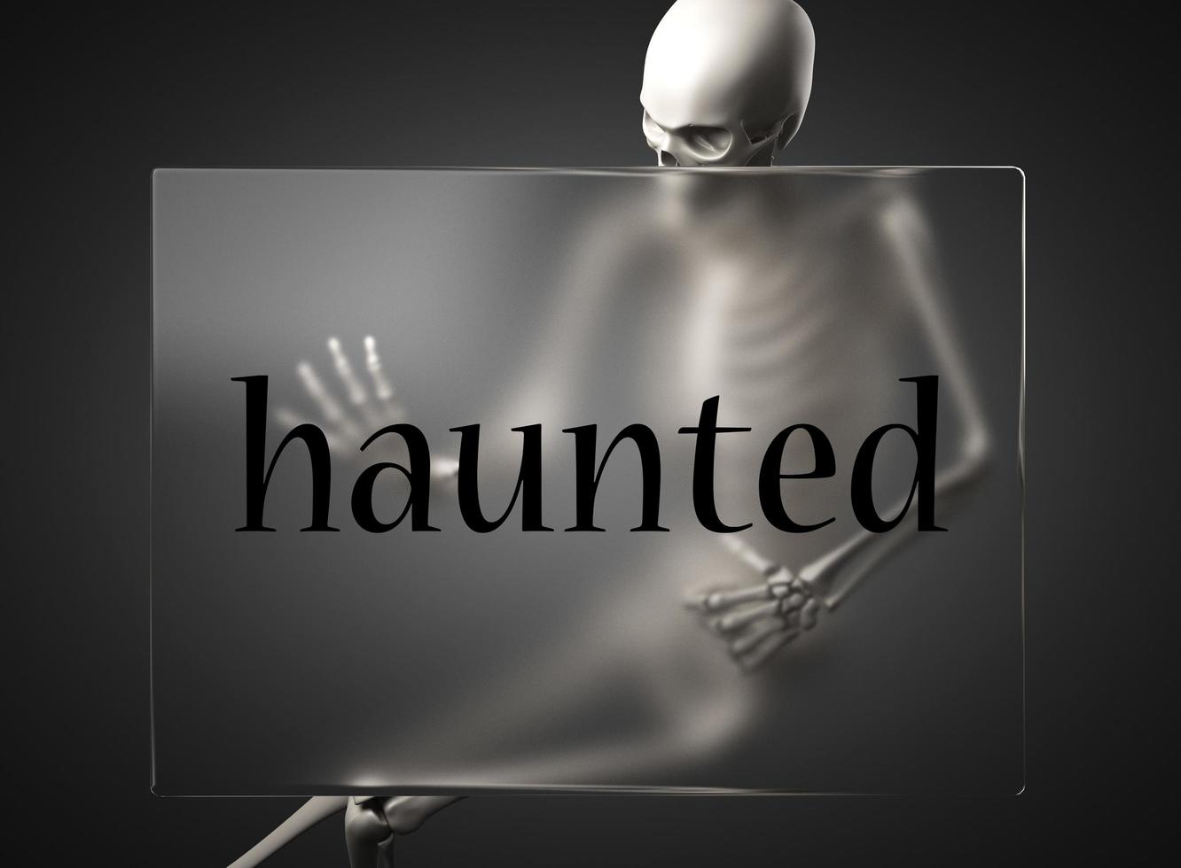 haunted word on glass and skeleton photo