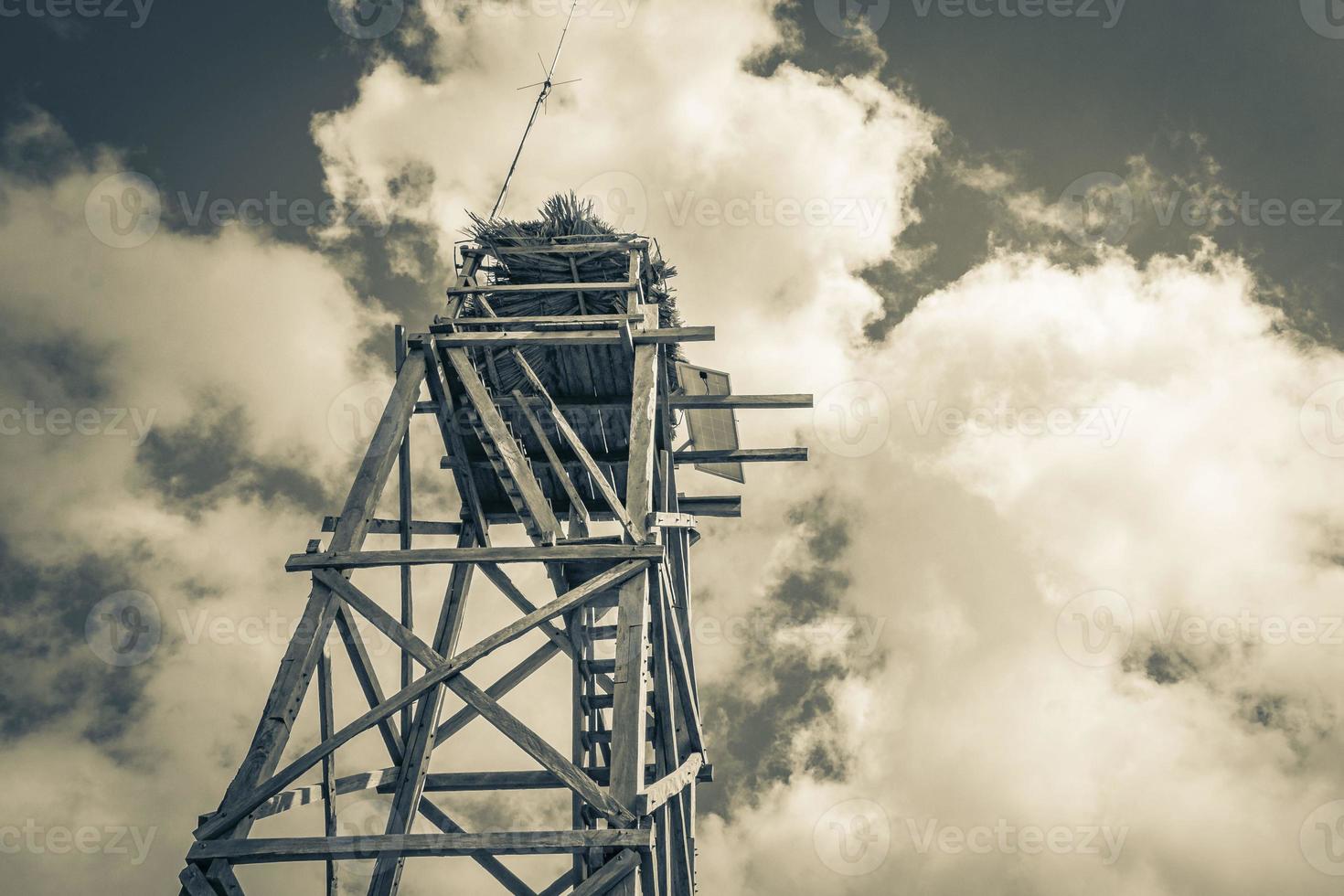 Wooden viewpoint tower with blue sky Muyil Lagoon panorama Mexico. photo