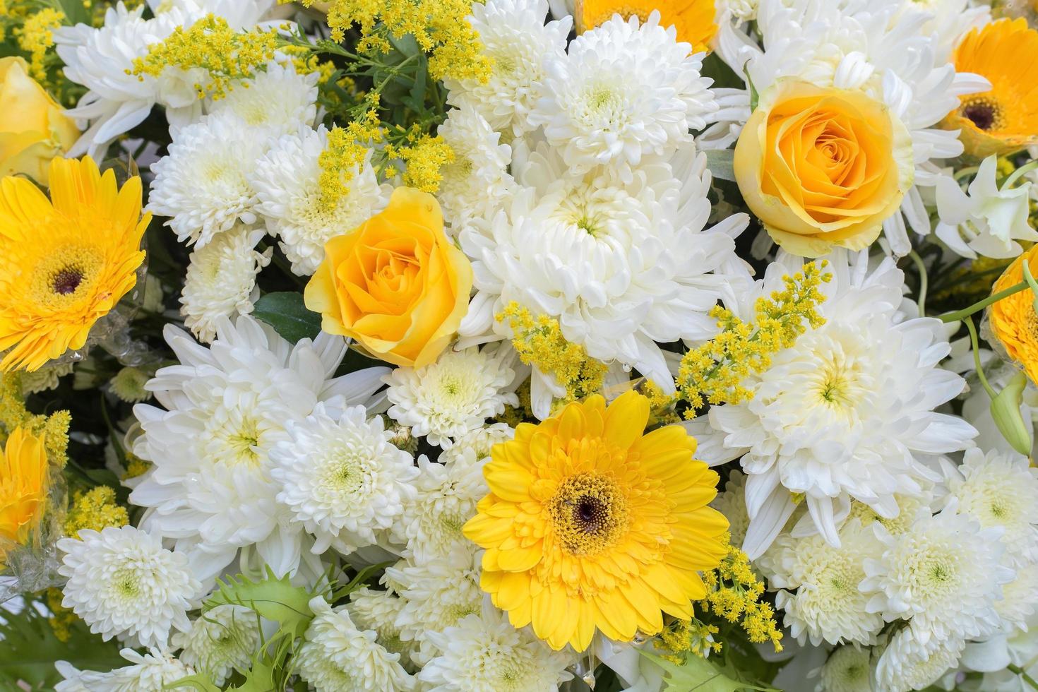 Yellow and white Chrysanthemum flowers, rose was decorated with green leaves as wreath to use in funeral. photo