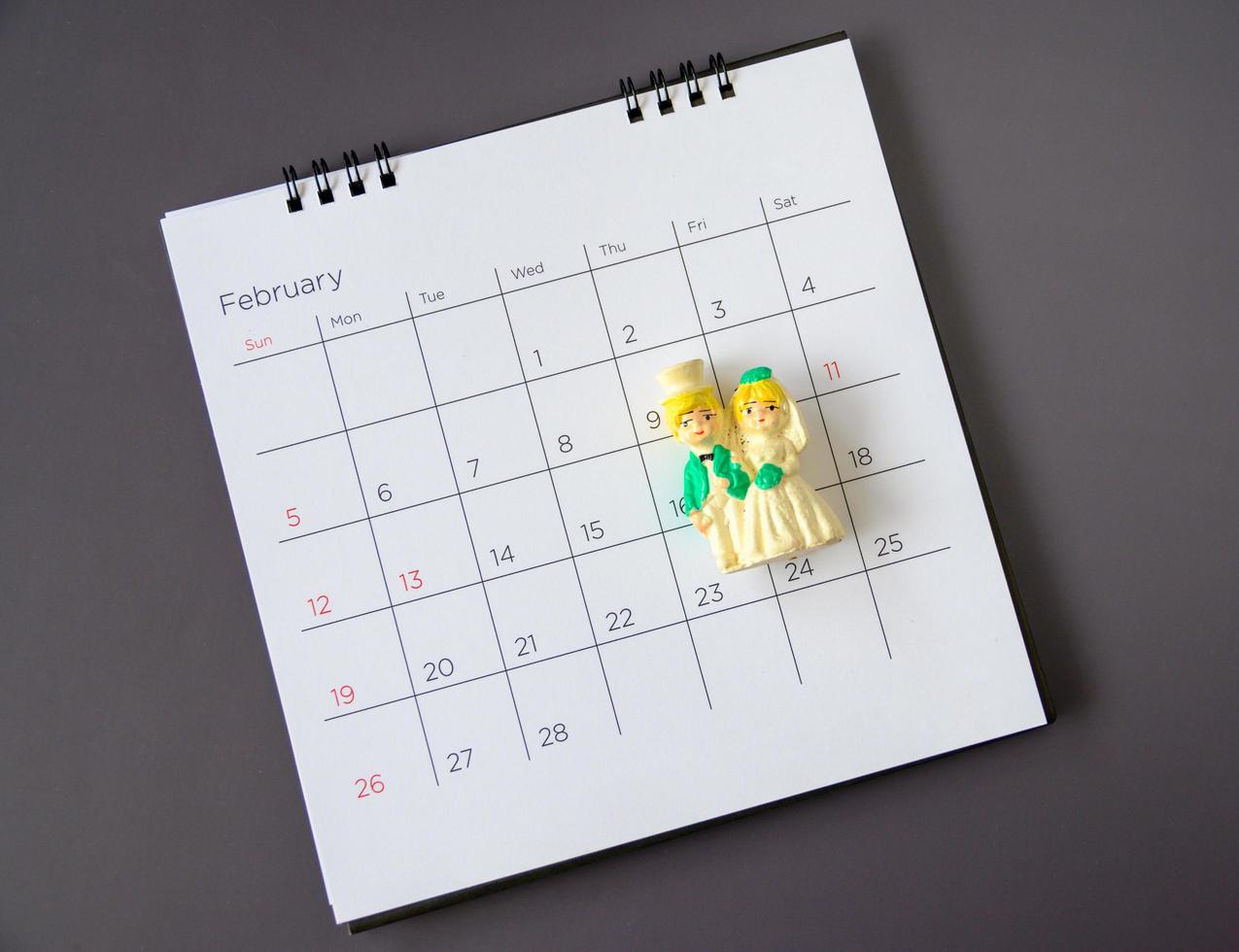 Miniature married couple on the calendar. photo