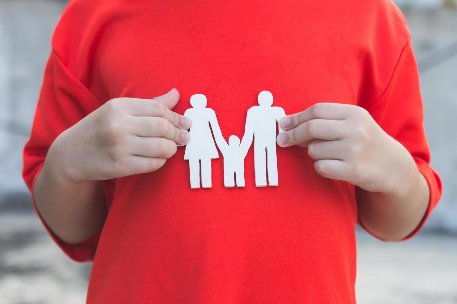 manos de los niños sosteniendo una familia modelo pequeña, familia conceptual foto