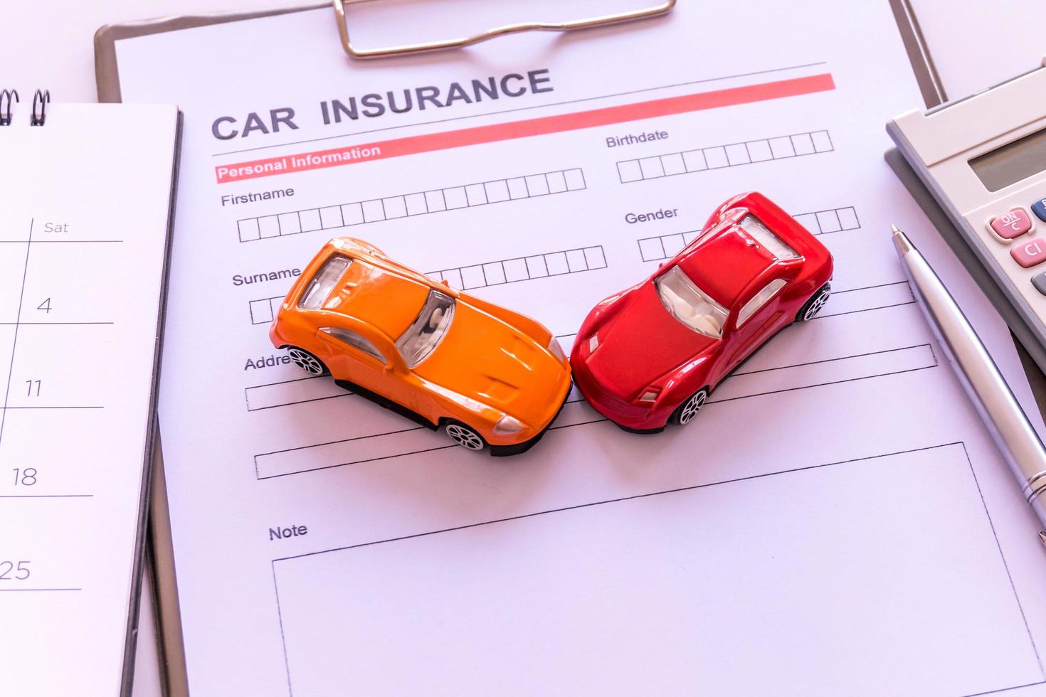 Car insurance form with model and policy document photo