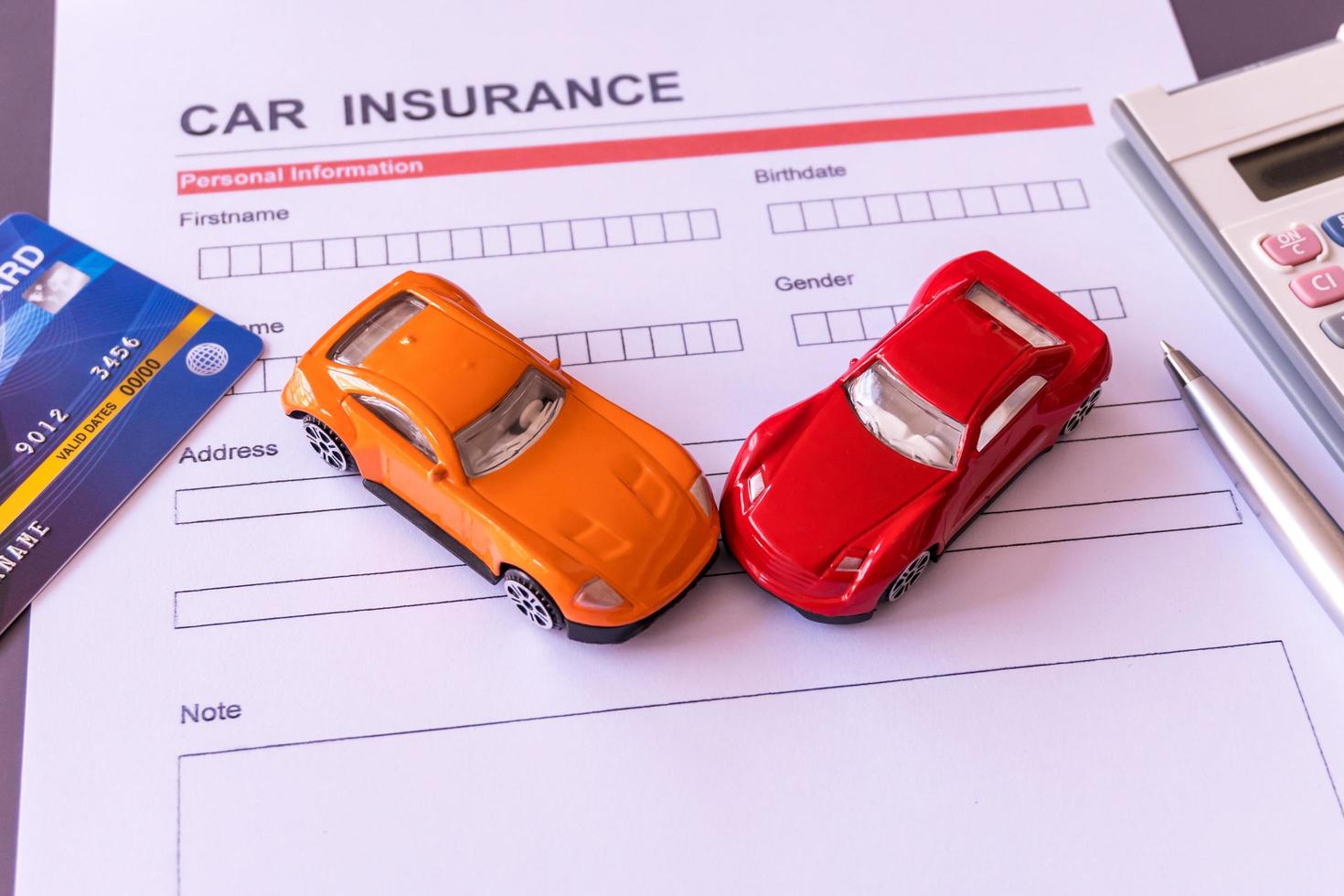 Car insurance form with model and policy document photo