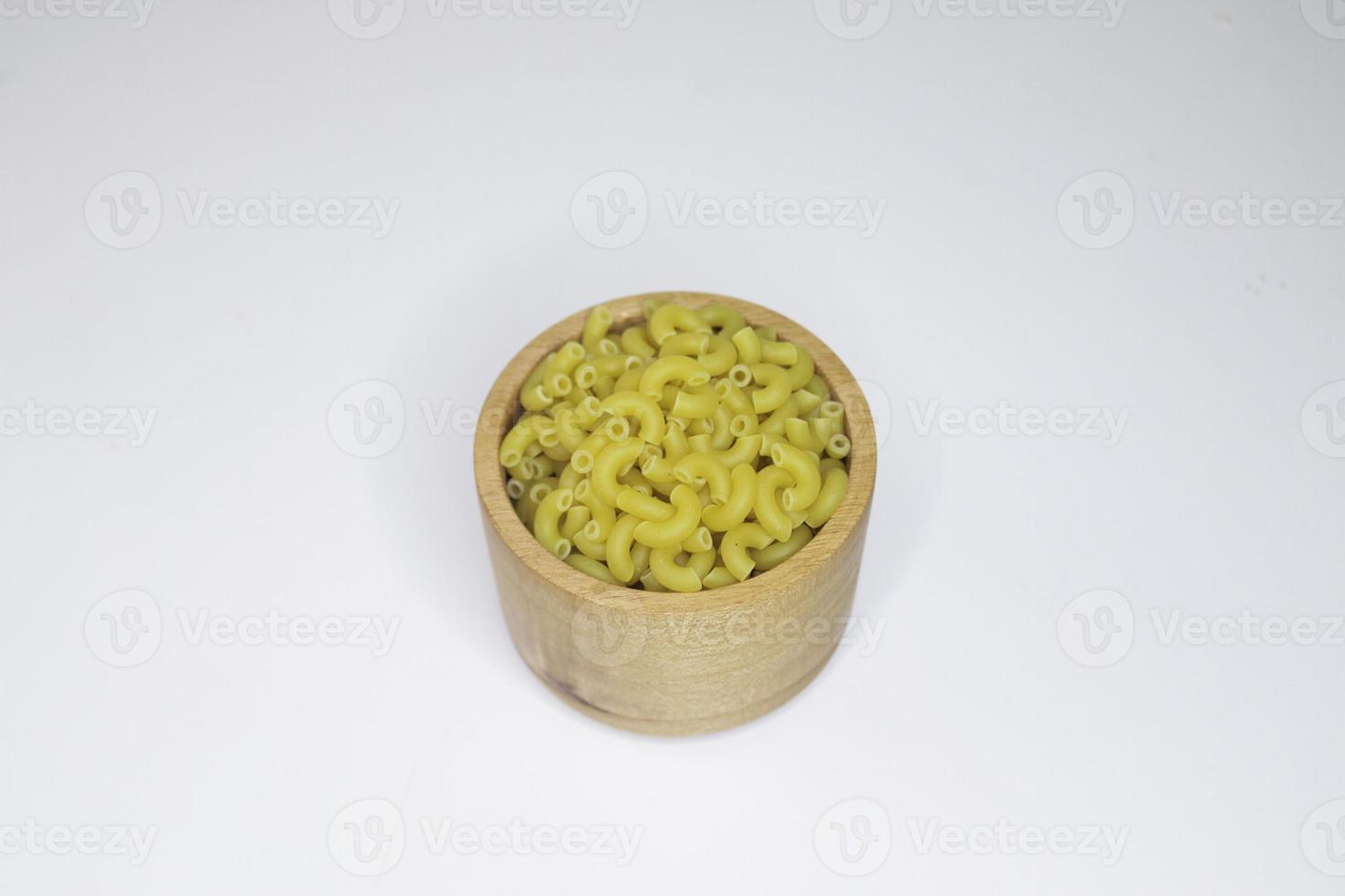 Top view of raw macaroni on white background. photo