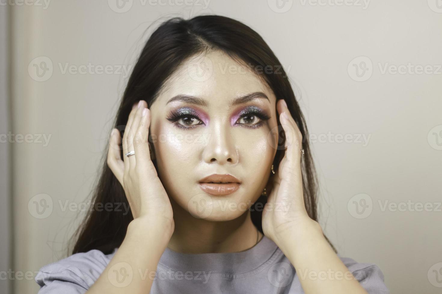 Conceptual beauty portrait of a beautiful young woman with colorful eyeshadow photo