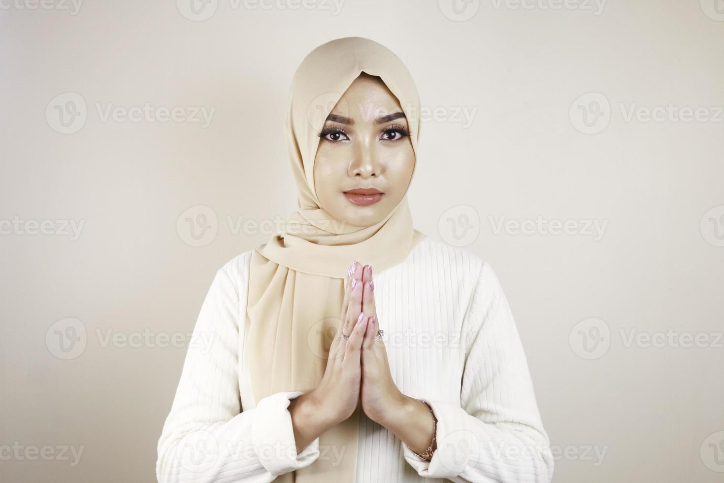 Portrait young beautiful Muslim woman wearing a hijab. Eid Mubarak greeting photo