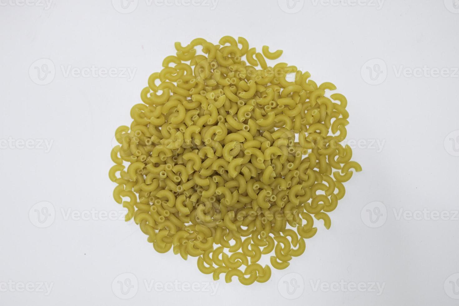 Top view of raw macaroni on white background. photo