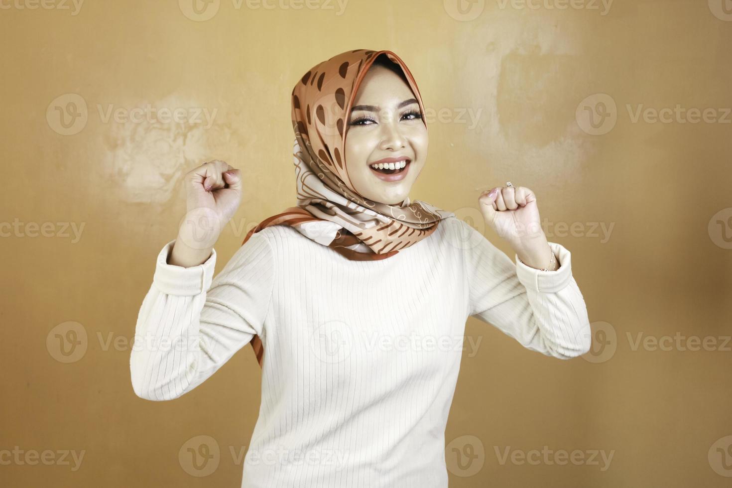 Beautiful muslim woman enthusiast, celebrating, yes. Success concept photo