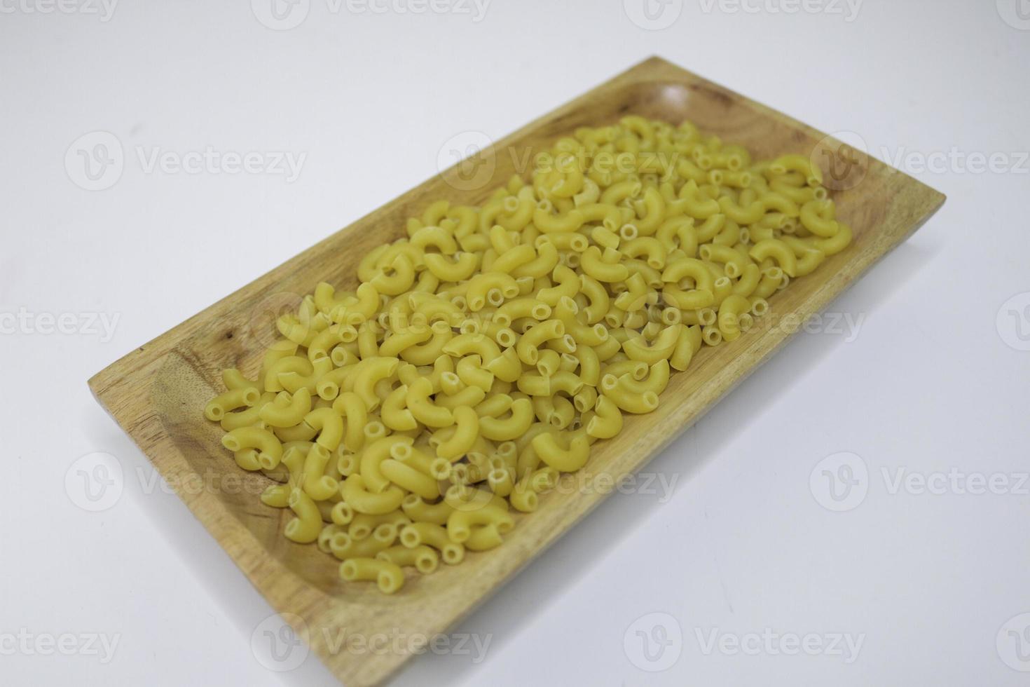 Top view of raw macaroni on white background. photo