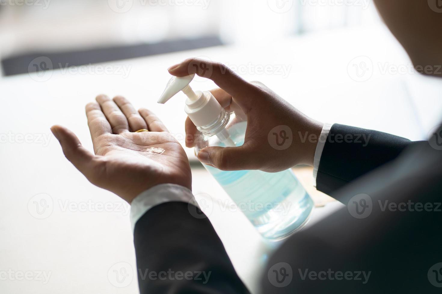 Business man washing hands with alcohol gel or antibacterial soap sanitizer  .Hygiene concept. prevent the spread of germs and bacteria and avoid infections corona virus photo