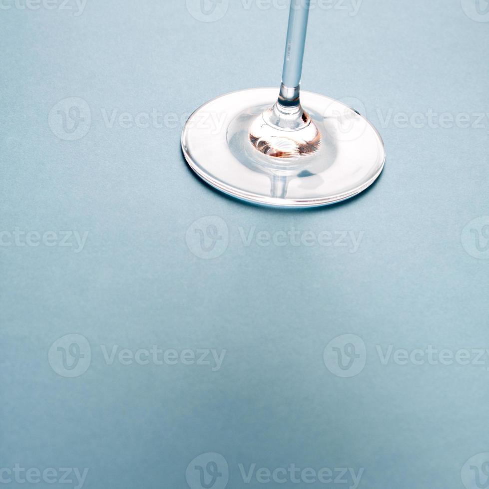 Wine glass base on blue background. photo