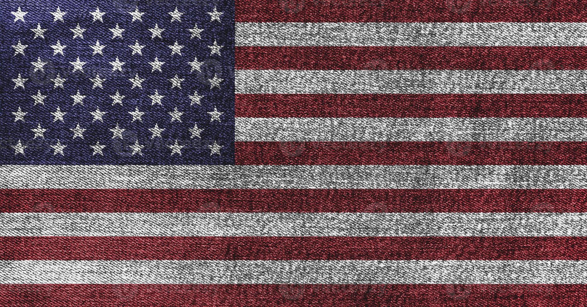 Grunge American flag on denim jeans textured abstract background concept. The National USA flag on denim frabric texture. photo