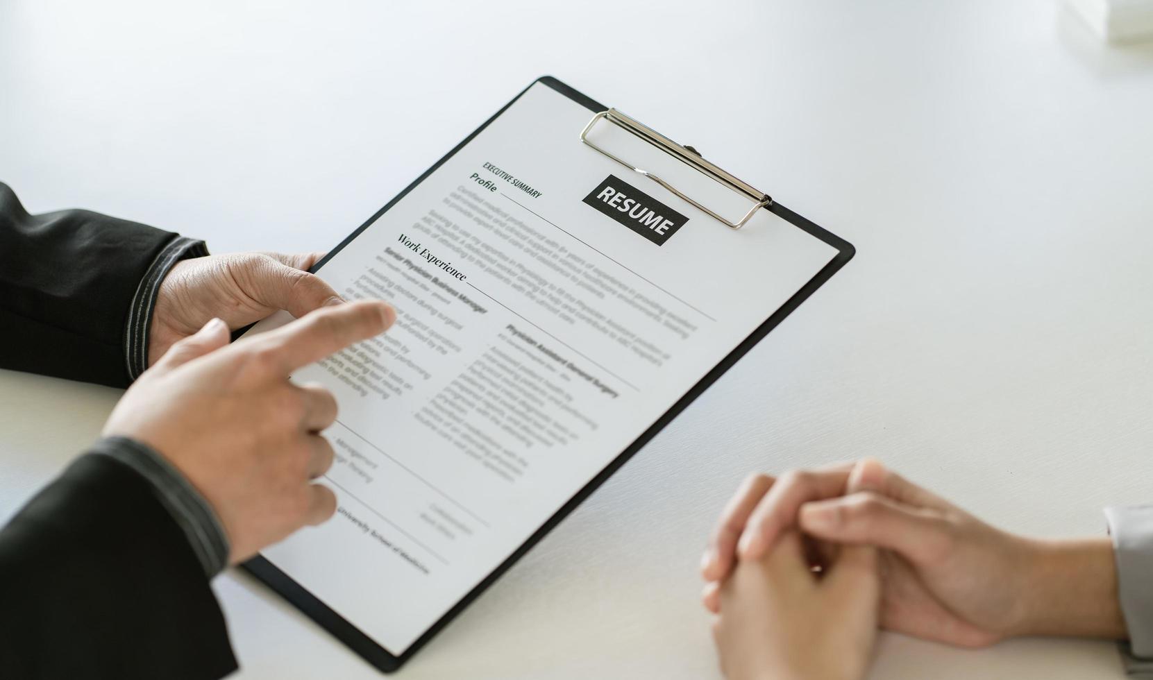 Close up businessman hands holding pen with document at meeting. Man making decision on business deal. Good business partners negotiation at job interview in office. photo