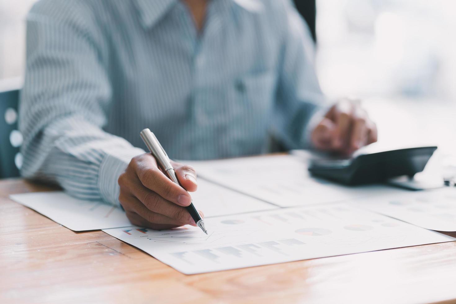Accountant working with data documents calculating on business report. business and invesment concept. photo
