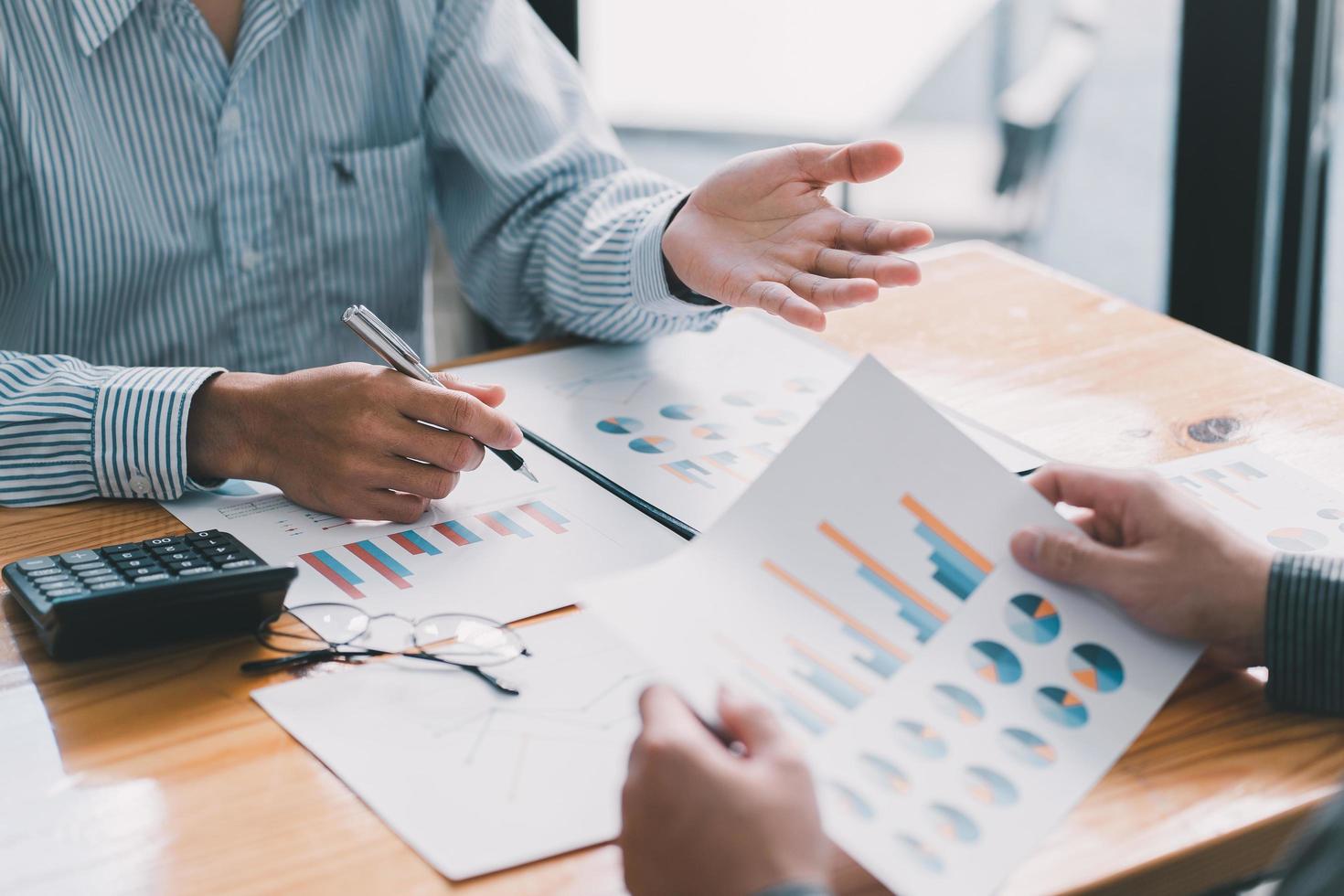 Business and investment concept. Business people discussing the charts and graphs showing the results of their successful teamwork. photo